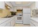 Clean and bright kitchen with white appliances at 3 Quails Run Blvd # 8, Englewood, FL 34223