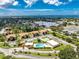 Aerial view of community pool and condo building at 3 Quails Run Blvd # 8, Englewood, FL 34223