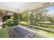 Relaxing screened porch with view of pond and trees at 3 Quails Run Blvd # 8, Englewood, FL 34223