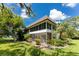 Building exterior with lush landscaping and pond view at 3 Quails Run Blvd # 8, Englewood, FL 34223