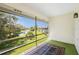 Screened porch with view of pond and lush landscape at 3 Quails Run Blvd # 8, Englewood, FL 34223