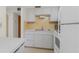 Efficient kitchen with white cabinets and appliances at 3 Quails Run Blvd # 8, Englewood, FL 34223
