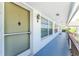 Building hallway with exterior door and windows at 3 Quails Run Blvd # 8, Englewood, FL 34223