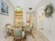 Bright dining area with a glass table and four chairs at 3 Quails Run Blvd # 8, Englewood, FL 34223