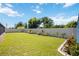 Large backyard with lush grass and nicely landscaped garden beds at 9273 Carnation Ave, Englewood, FL 34224