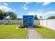 Backyard view of a blue shed and well maintained lawn at 9273 Carnation Ave, Englewood, FL 34224