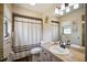 Clean bathroom with shower/tub combo, vanity, and updated fixtures at 9273 Carnation Ave, Englewood, FL 34224