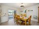 Charming dining area with glass-top table and access to a sunroom at 9273 Carnation Ave, Englewood, FL 34224