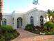 Community clubhouse with attractive landscaping and a welcoming entrance at 1418 Backspin Dr, Englewood, FL 34223