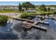 Community boat dock with multiple slips and a boat at 130 Nautical Dr, North Port, FL 34287