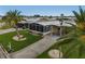 An aerial view shows a manufactured home with carport and a screened-in porch at 130 Nautical Dr, North Port, FL 34287