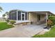 The home has a carport, screened porch, and landscaping at 130 Nautical Dr, North Port, FL 34287
