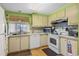 Bright kitchen with ample cabinetry, modern appliances, and wood flooring at 130 Nautical Dr, North Port, FL 34287