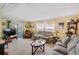 Bright living room with two sofas, a coffee table and access to a screened porch at 130 Nautical Dr, North Port, FL 34287