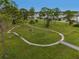 Community park with walking path and picnic tables at 130 Nautical Dr, North Port, FL 34287