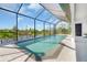 Sparkling pool in screened enclosure offers a serene waterfront view, perfect for swimming and relaxation at 10454 Atenia St, Port Charlotte, FL 33981