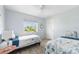Two twin beds, light blue walls, and a ceiling fan at 2375 N Beach Rd # 3A, Englewood, FL 34223