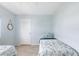 Guest bedroom with two twin beds and light walls at 2375 N Beach Rd # 3A, Englewood, FL 34223
