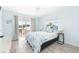 Main bedroom with king bed and private balcony access at 2375 N Beach Rd # 3A, Englewood, FL 34223