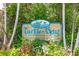Turtle Bay community sign with contact information for rentals at 2375 N Beach Rd # 3A, Englewood, FL 34223