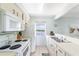 Clean galley kitchen boasts water views and white appliances at 2375 N Beach Rd # 3A, Englewood, FL 34223