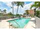 Community pool with lounge chairs and building view at 2375 N Beach Rd # 3A, Englewood, FL 34223