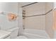 Bright bathroom features a tub-shower combo with decorative tile surround and new fixtures at 470 S Mccall Rd # 10, Englewood, FL 34223