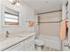 Bathroom with updated white vanity, quartz counters, and tub-shower combo with decorative tile surround at 470 S Mccall Rd # 10, Englewood, FL 34223