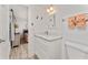 Bathroom features updated vanity with quartz counters, door to bedroom, and soft peach colored towels at 470 S Mccall Rd # 10, Englewood, FL 34223