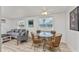 Charming dining area features a glass table with wicker chairs, perfect for intimate meals at 470 S Mccall Rd # 10, Englewood, FL 34223