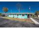 Charming turquoise home with white trim and a screened-in porch offers a cozy coastal feel at 470 S Mccall Rd # 10, Englewood, FL 34223
