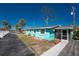 Charming turquoise home with a screened-in porch and mature palm trees, offering a serene retreat at 470 S Mccall Rd # 10, Englewood, FL 34223
