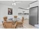 Bright kitchen features a glass table with wicker chairs, bright white walls and tile at 470 S Mccall Rd # 10, Englewood, FL 34223
