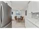 Modern kitchen with sleek white cabinets, gray backsplash, and stainless-steel appliances at 470 S Mccall Rd # 10, Englewood, FL 34223