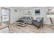 Bright living room with a comfortable gray sofa and chair, and lots of natural light at 470 S Mccall Rd # 10, Englewood, FL 34223