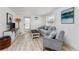 Inviting living room features a gray sofa, accent chair, modern decor, and light wood flooring at 470 S Mccall Rd # 10, Englewood, FL 34223