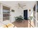 Cozy screened patio with a ceiling fan and dining set, perfect for enjoying the outdoors at 470 S Mccall Rd # 10, Englewood, FL 34223