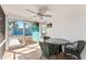 Inviting screened patio with ceiling fan and tile flooring, ideal for outdoor dining at 470 S Mccall Rd # 10, Englewood, FL 34223