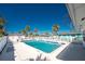 Community pool is surrounded by tropical landscaping and white fencing for added security and peace of mind at 470 S Mccall Rd # 10, Englewood, FL 34223