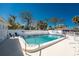 Community pool is surrounded by well maintained landscaping and white fencing for added security at 470 S Mccall Rd # 10, Englewood, FL 34223