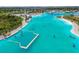 Breathtaking aerial shot of the community lagoon, showcasing a dock, and various water activities at 7537 Pool Compass Loop, Wesley Chapel, FL 33545