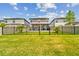 Fenced backyard boasts a well-manicured lawn, paver patio, and a tranquil setting for outdoor enjoyment at 7537 Pool Compass Loop, Wesley Chapel, FL 33545