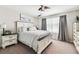 Bright bedroom with a ceiling fan, soft gray curtains, and a decorative pillow on the well-made bed at 7537 Pool Compass Loop, Wesley Chapel, FL 33545
