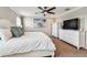 Cozy bedroom featuring a queen bed, ceiling fan, and beach-themed artwork creating a relaxing ambiance at 7537 Pool Compass Loop, Wesley Chapel, FL 33545