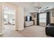 Bedroom with a sitting area, featuring a large TV, and view of bedroom at 7537 Pool Compass Loop, Wesley Chapel, FL 33545