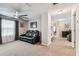 Bedroom with a comfortable leather couch and carpeted floors at 7537 Pool Compass Loop, Wesley Chapel, FL 33545