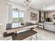 Stylish dining area with dark wood table, bench seating and modern chandelier at 7537 Pool Compass Loop, Wesley Chapel, FL 33545