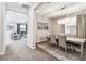 Elegant dining room featuring a modern chandelier and neutral tones, open to the cozy living room at 7537 Pool Compass Loop, Wesley Chapel, FL 33545