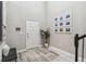Bright foyer with high ceilings, modern decor, and tiled flooring at 7537 Pool Compass Loop, Wesley Chapel, FL 33545