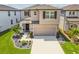 Charming two-story home with a manicured lawn, stone accents, and a spacious two-car garage at 7537 Pool Compass Loop, Wesley Chapel, FL 33545